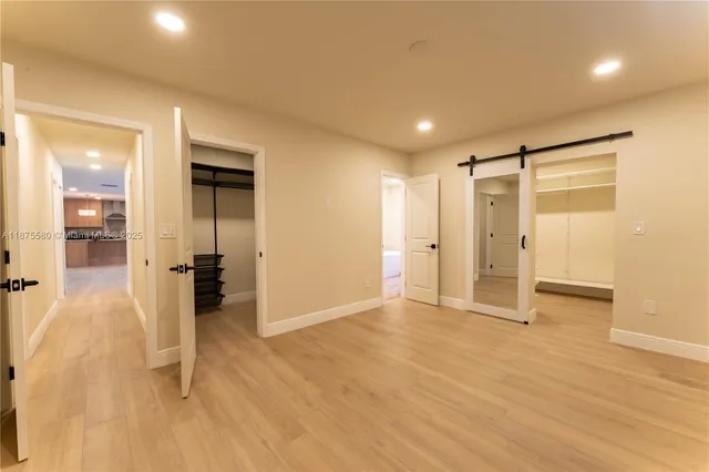 a view of a hallway with wooden shelves