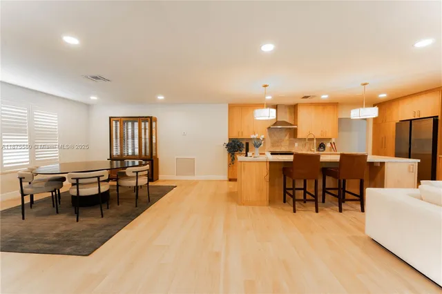 a living room with lots of furniture and kitchen view