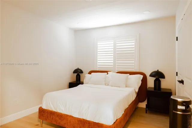 a bedroom with a bed and a night stand