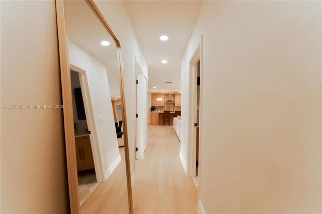 a view of hallway with wooden floor