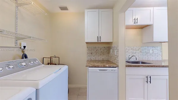 a kitchen that has a sink and a stove
