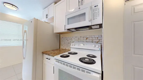 a kitchen with a stove and a refrigerator