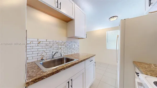a kitchen with a sink cabinets and a stove