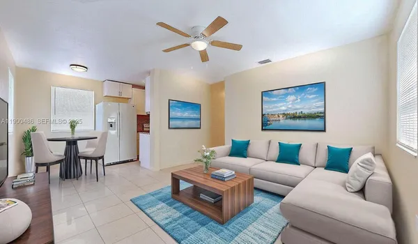a living room with furniture a view of bedroom and a window