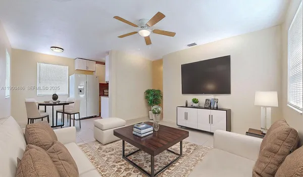 a living room with furniture a rug and a flat screen tv