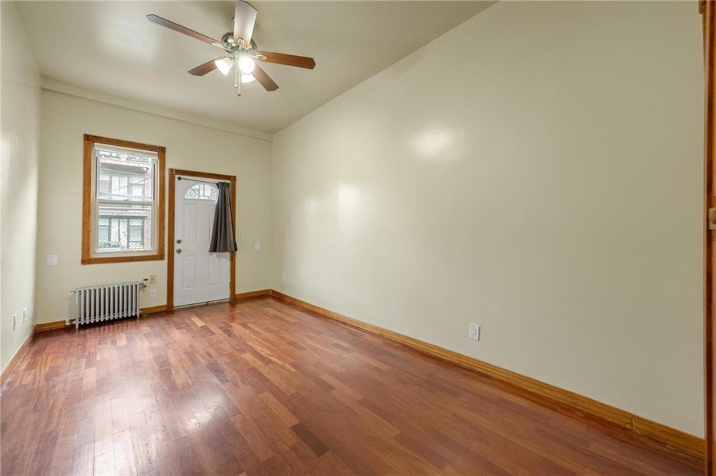 219 16th Street Brooklyn, NY 11215 - Photo 8 of 11 an empty room with windows and ceiling fan