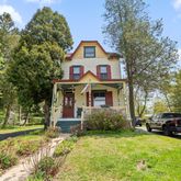 a front view of a house with garden