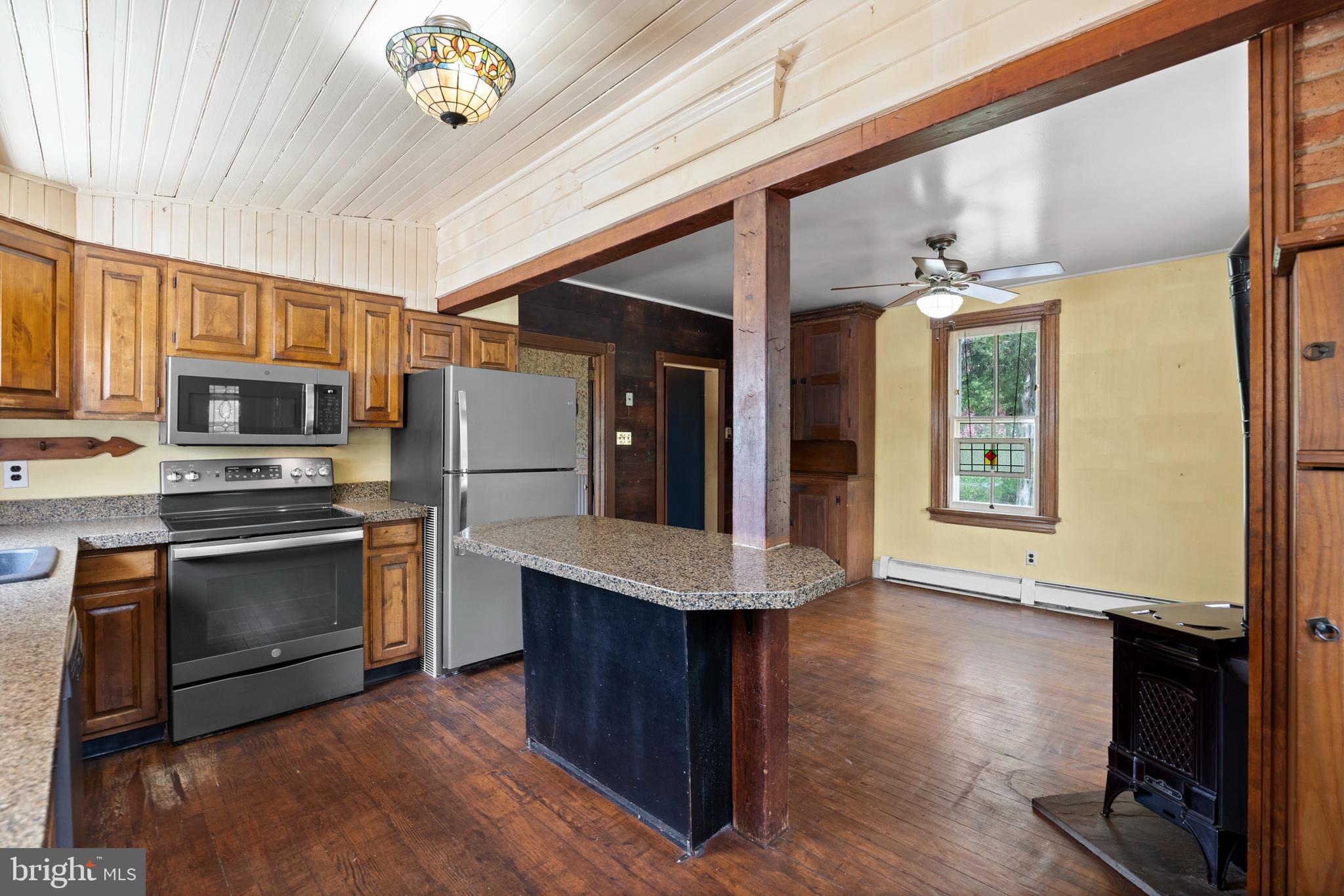 40 Barren Road Media, PA 19063 - Photo 27 of 30 a kitchen with stainless steel appliances granite countertop a stove top oven a sink dishwasher a microwave oven and a refrigerator with wooden floor