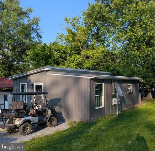 a view of a back yard of the house and car parked