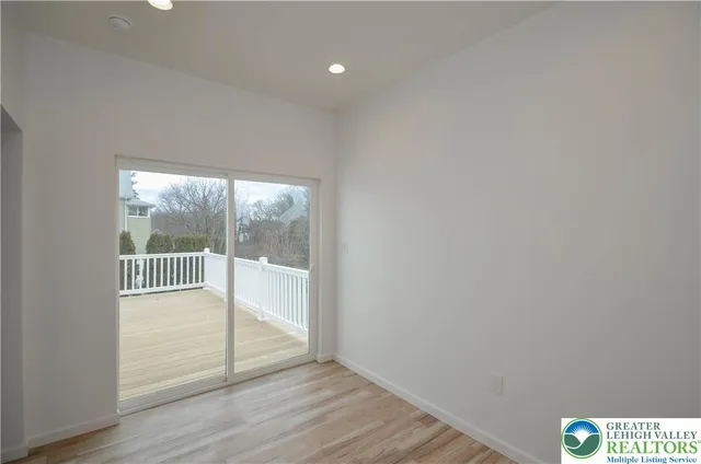 a spacious bathroom with a granite countertop sink toilet a large mirror a bathtub and shower