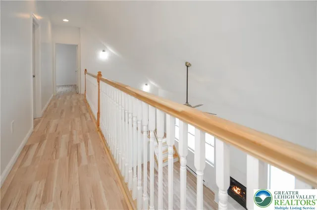 a view of a room with wooden floor fan and a window