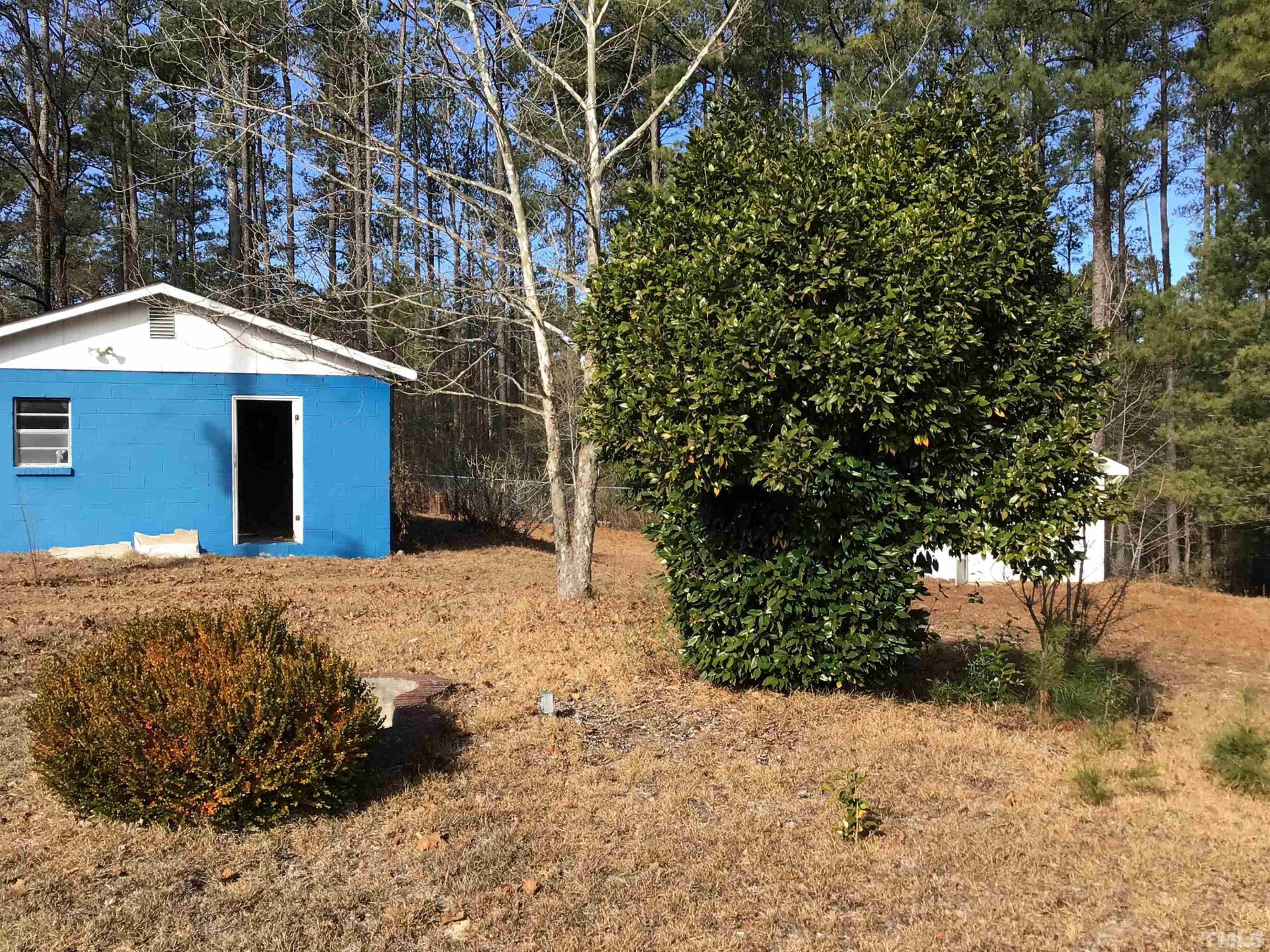 631 Cartledge Creek Road Rockingham, NC 28379 - Photo 40 of 74 a white house that has a tree in front of it