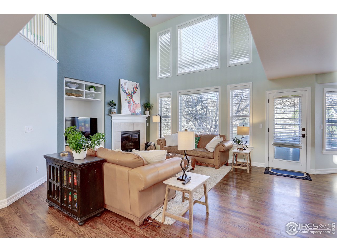 11744 Riverview Road Longmont, CO 80504 - Photo 13 of 40 a living room with furniture a large window and a fireplace