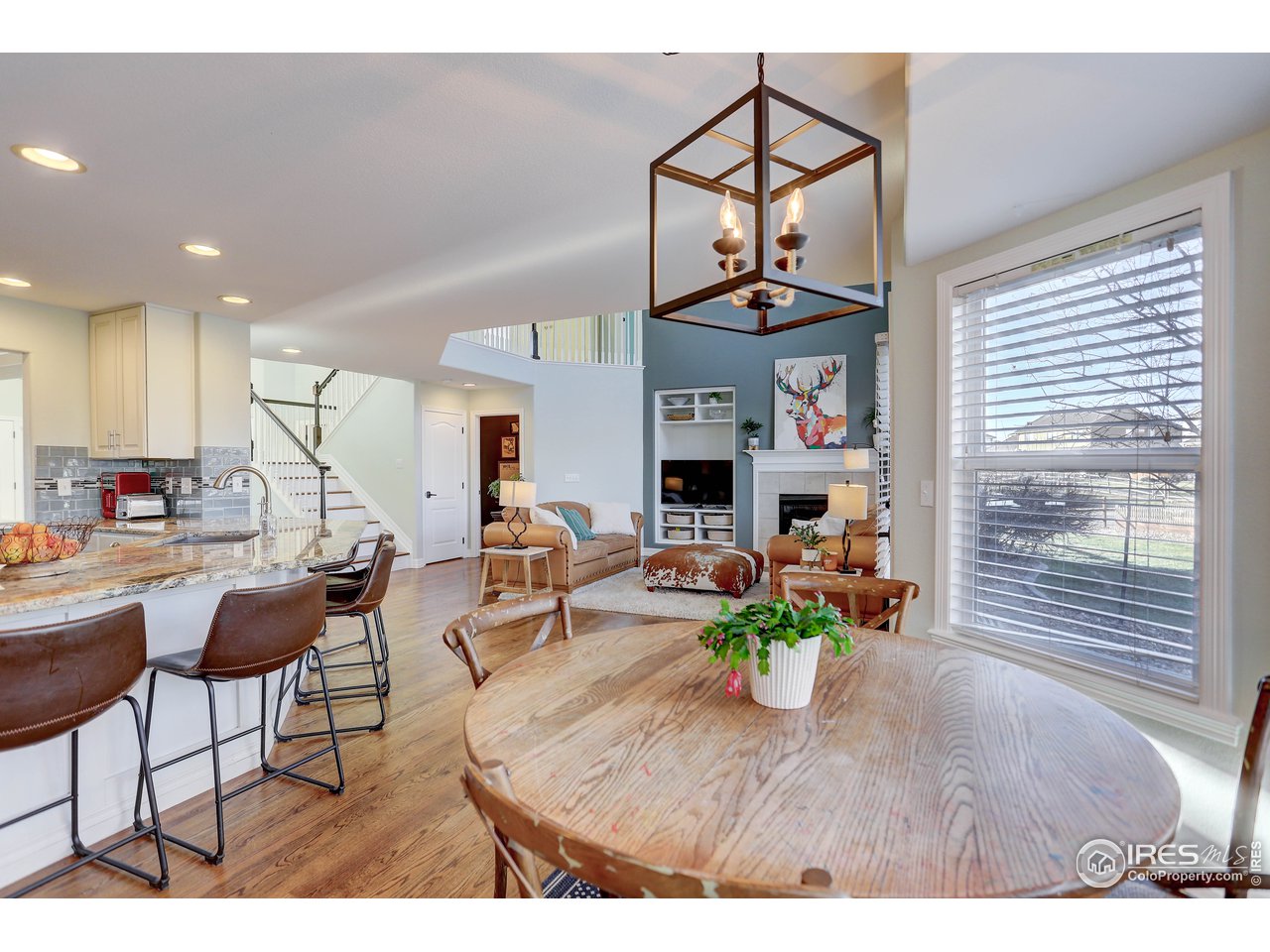 11744 Riverview Road Longmont, CO 80504 - Photo 17 of 40 a living room with furniture a window and a chandelier