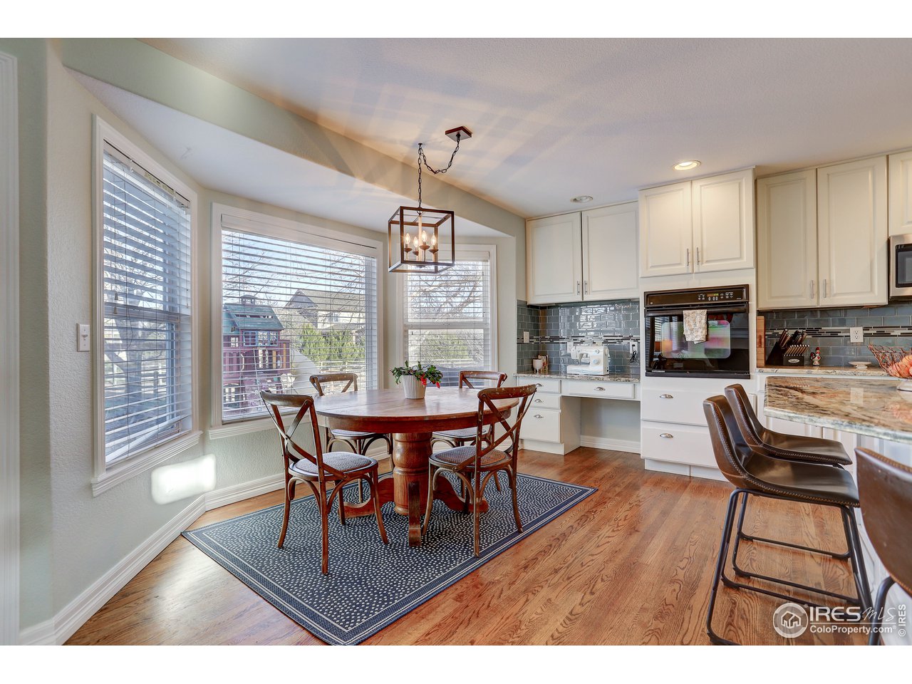 11744 Riverview Road Longmont, CO 80504 - Photo 18 of 40 a dining room with furniture and wooden floor