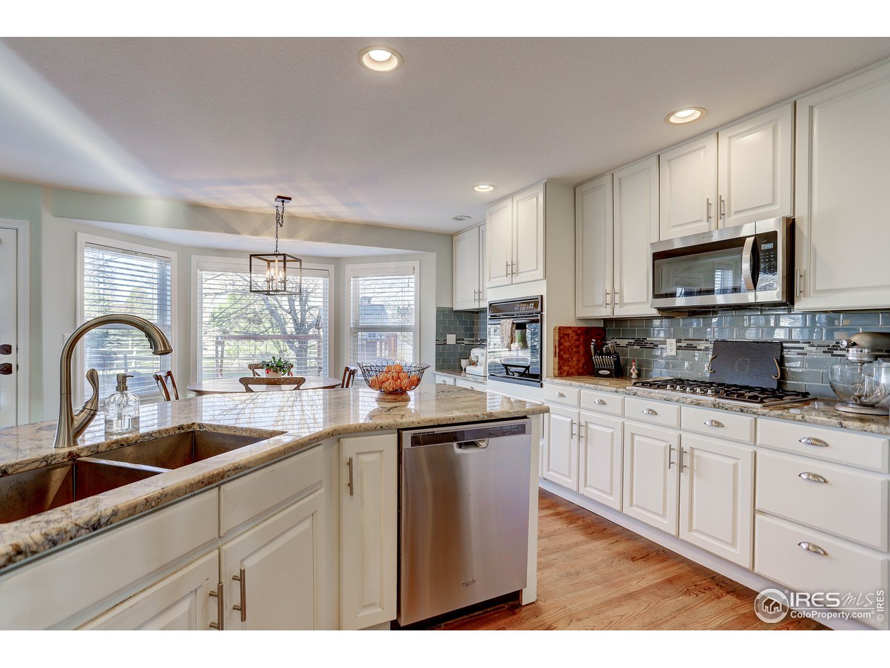11744 Riverview Road Longmont, CO 80504 - Photo 21 of 40 a kitchen with sink a stove and cabinets