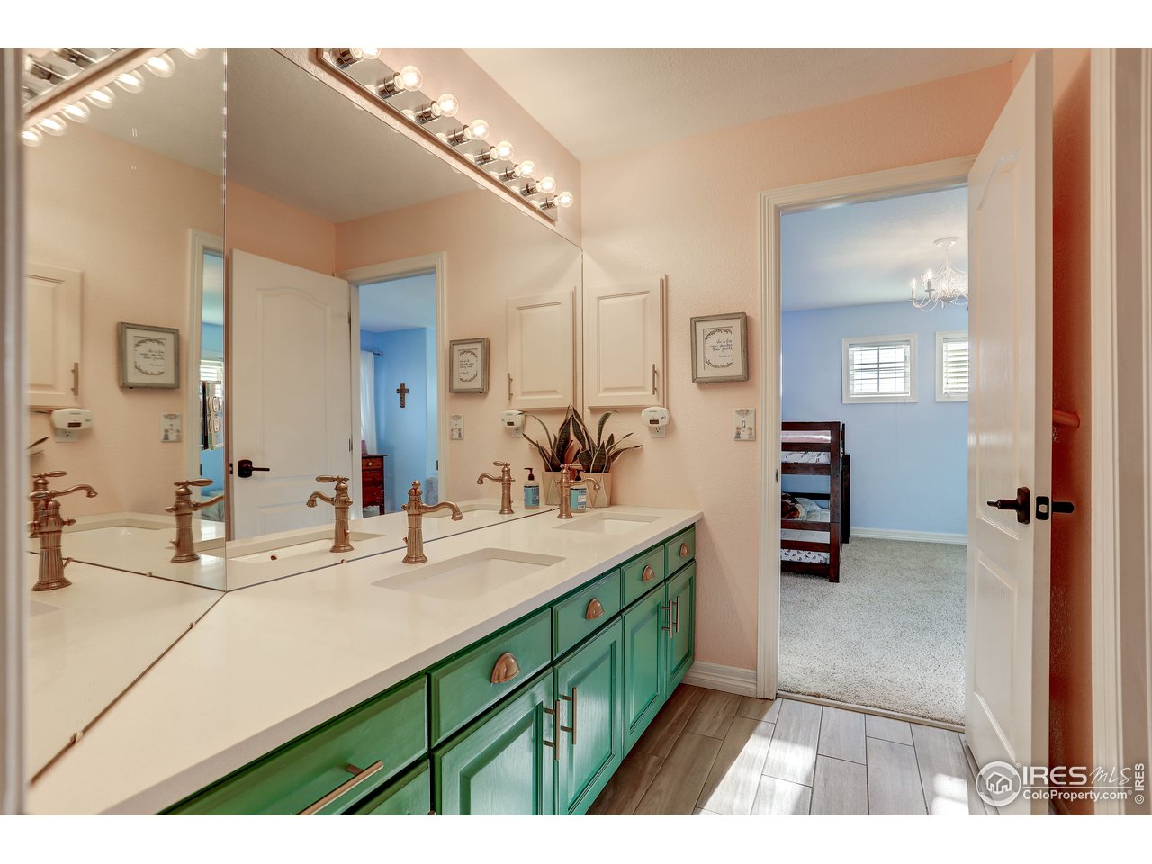 11744 Riverview Road Longmont, CO 80504 - Photo 26 of 40 a bathroom with a sink double vanity and a mirror