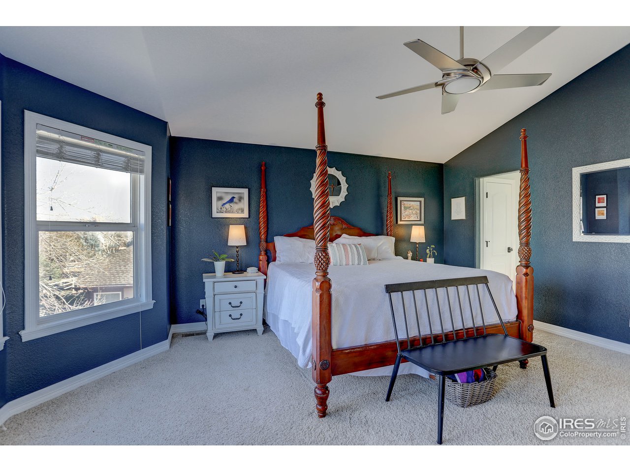 11744 Riverview Road Longmont, CO 80504 - Photo 29 of 40 a bedroom with a bed and a chandelier