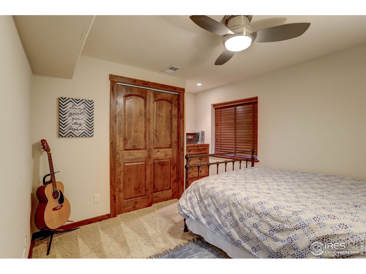 11744 Riverview Road Longmont, CO 80504 - Photo 34 of 40 a bedroom with a bed and a chandelier