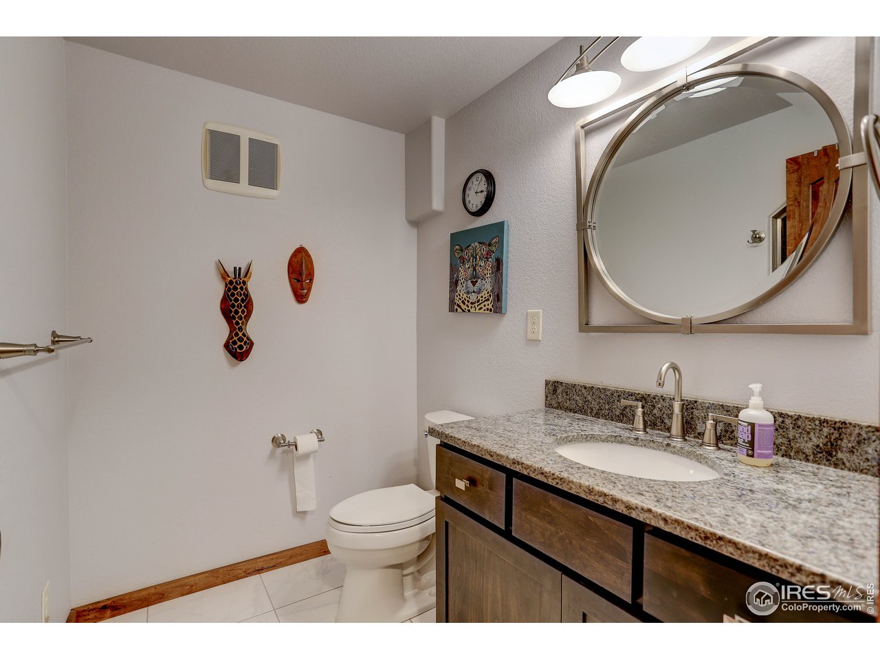 11744 Riverview Road Longmont, CO 80504 - Photo 35 of 40 a bathroom with a granite countertop toilet sink and mirror