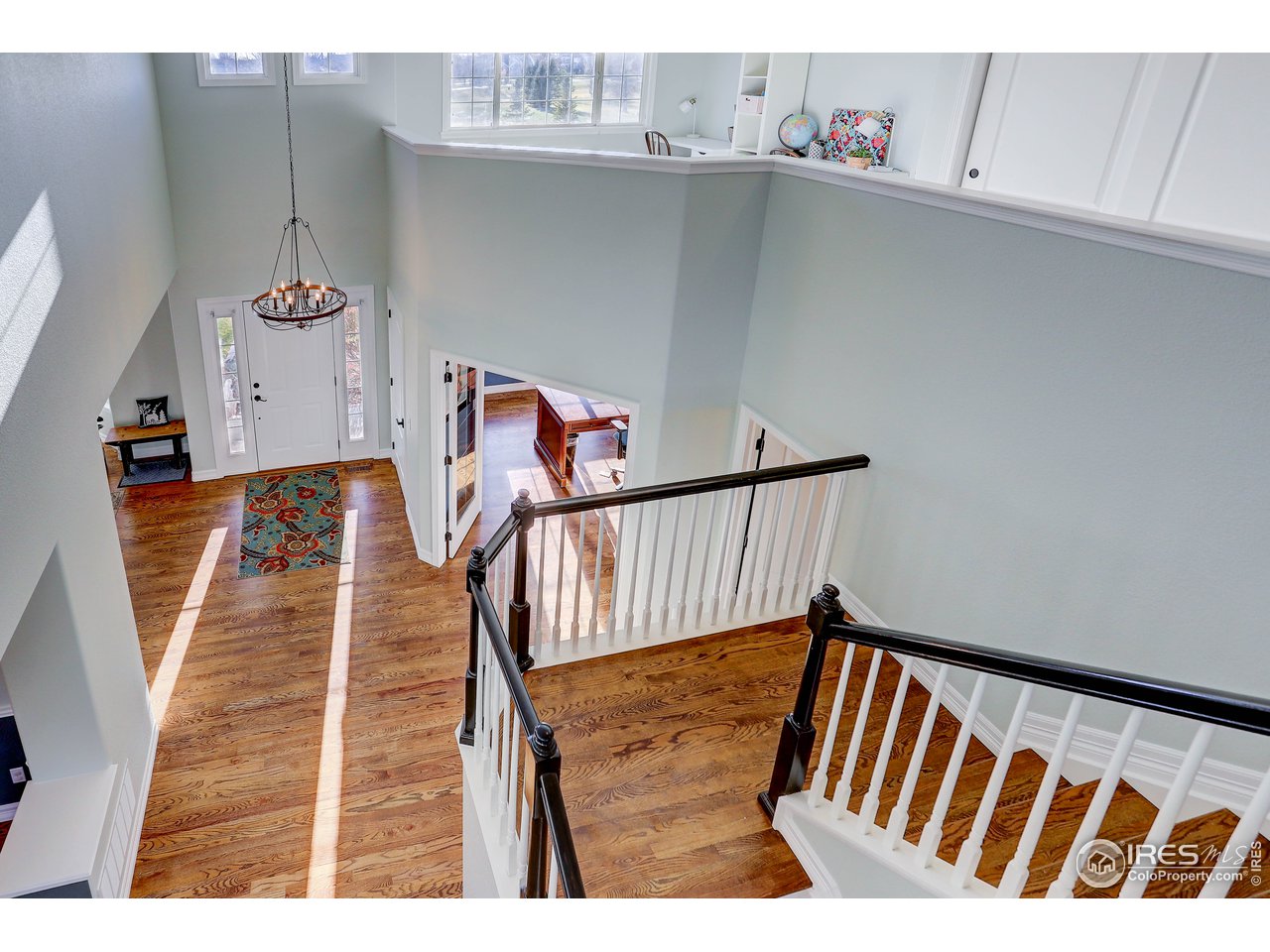 11744 Riverview Road Longmont, CO 80504 - Photo 6 of 40 a view of a hallway with wooden floor and staircase