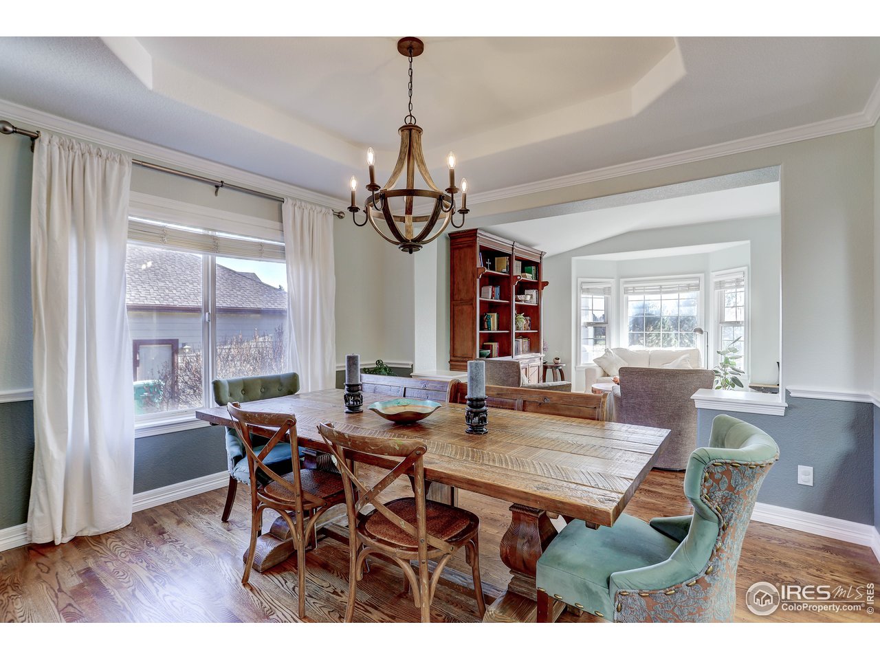 11744 Riverview Road Longmont, CO 80504 - Photo 9 of 40 a view of a dining room with furniture window and wooden floor