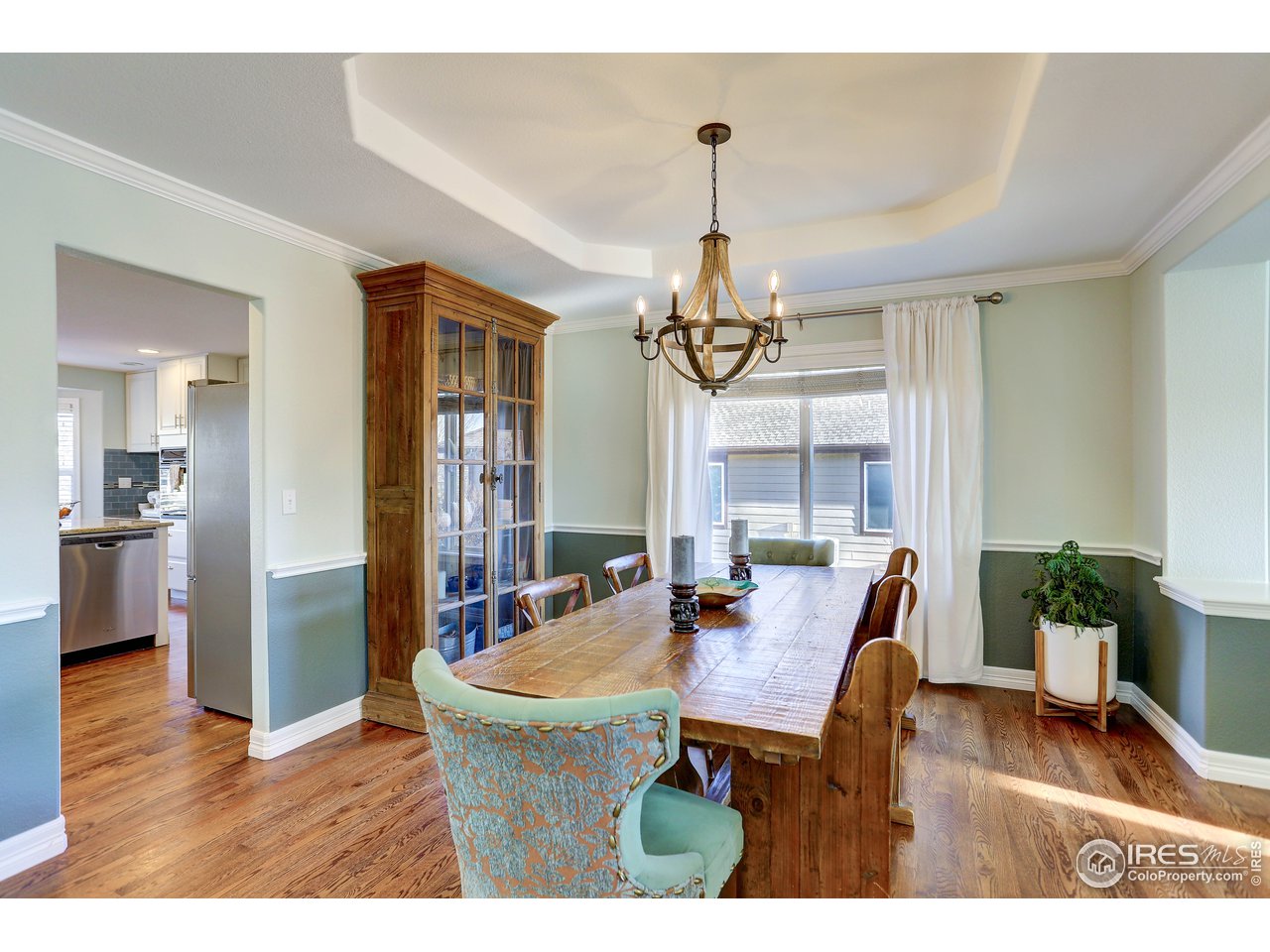 11744 Riverview Road Longmont, CO 80504 - Photo 10 of 40 a view of a dining room with furniture window and wooden floor