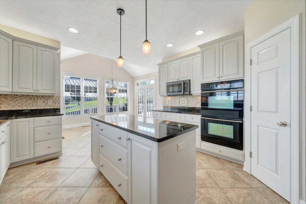 220 Settlers Road Fincastle, VA 24090 - Photo 27 of 106 a kitchen with stainless steel appliances granite countertop a stove a sink and a refrigerator