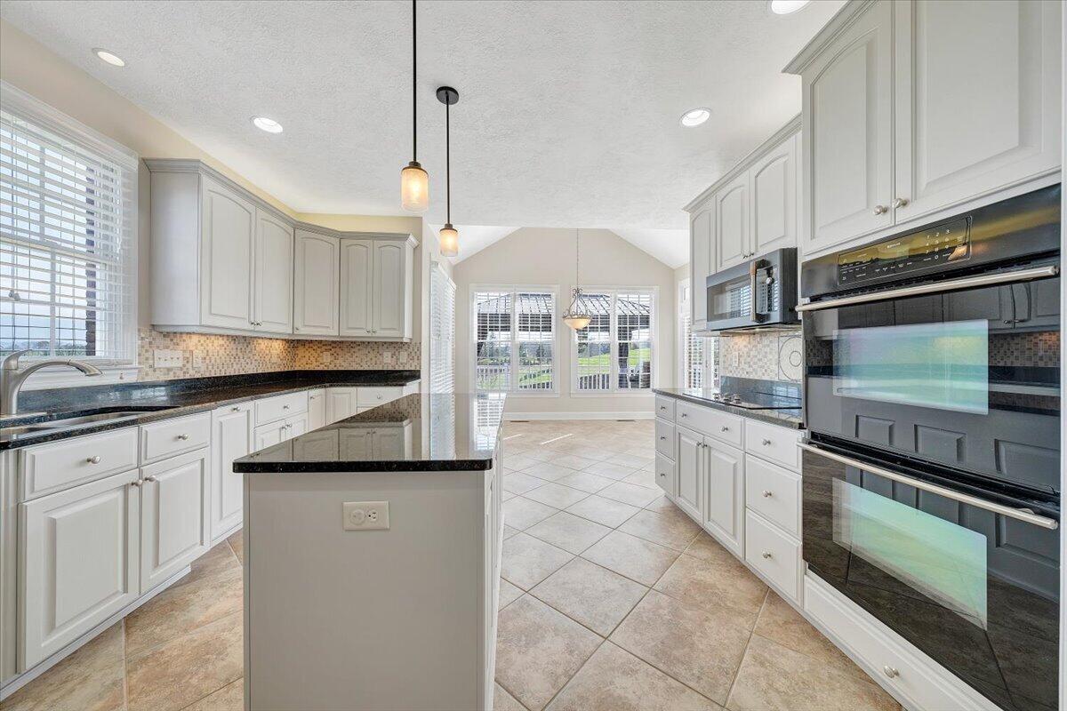 220 Settlers Road Fincastle, VA 24090 - Photo 28 of 106 a kitchen with stainless steel appliances granite countertop a stove a sink and a microwave