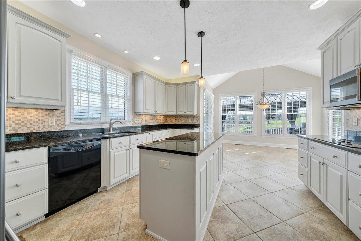 220 Settlers Road Fincastle, VA 24090 - Photo 29 of 106 a large kitchen with granite countertop a stove a sink and a refrigerator