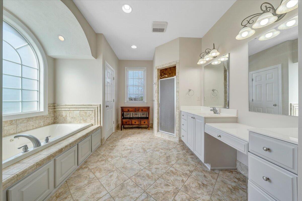 220 Settlers Road Fincastle, VA 24090 - Photo 42 of 106 a large white bathroom with a large tub double vanity sink and a large mirror