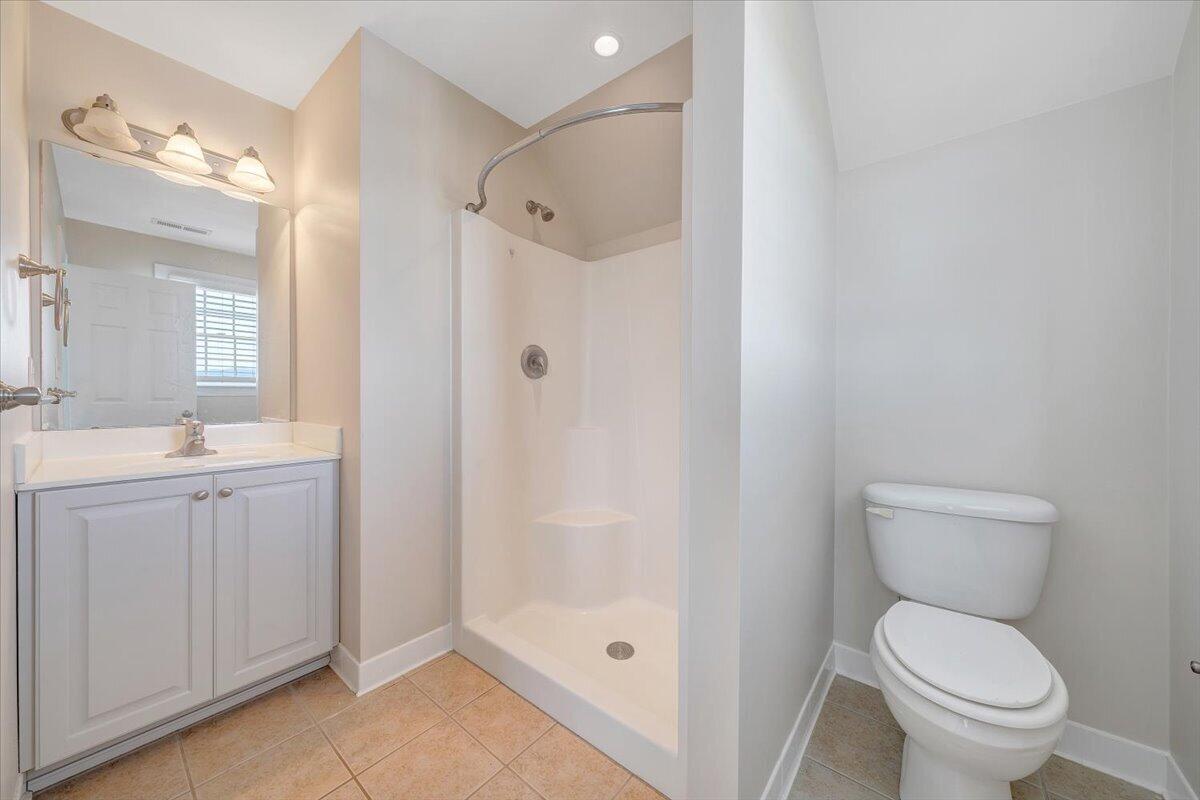 220 Settlers Road Fincastle, VA 24090 - Photo 59 of 106 a bathroom with a granite countertop toilet a sink and a mirror