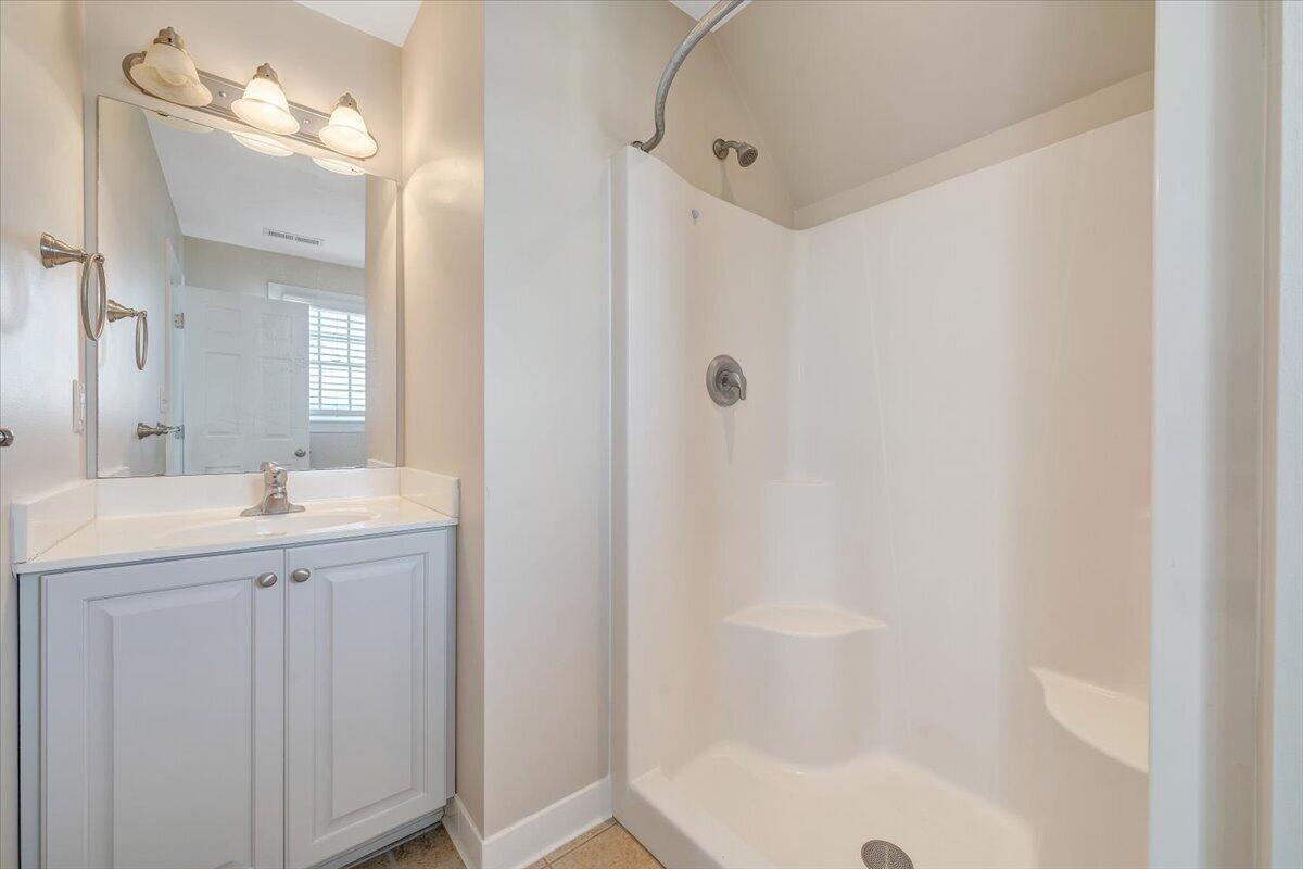 220 Settlers Road Fincastle, VA 24090 - Photo 60 of 106 a bathroom with a granite countertop sink a mirror and a bathtub