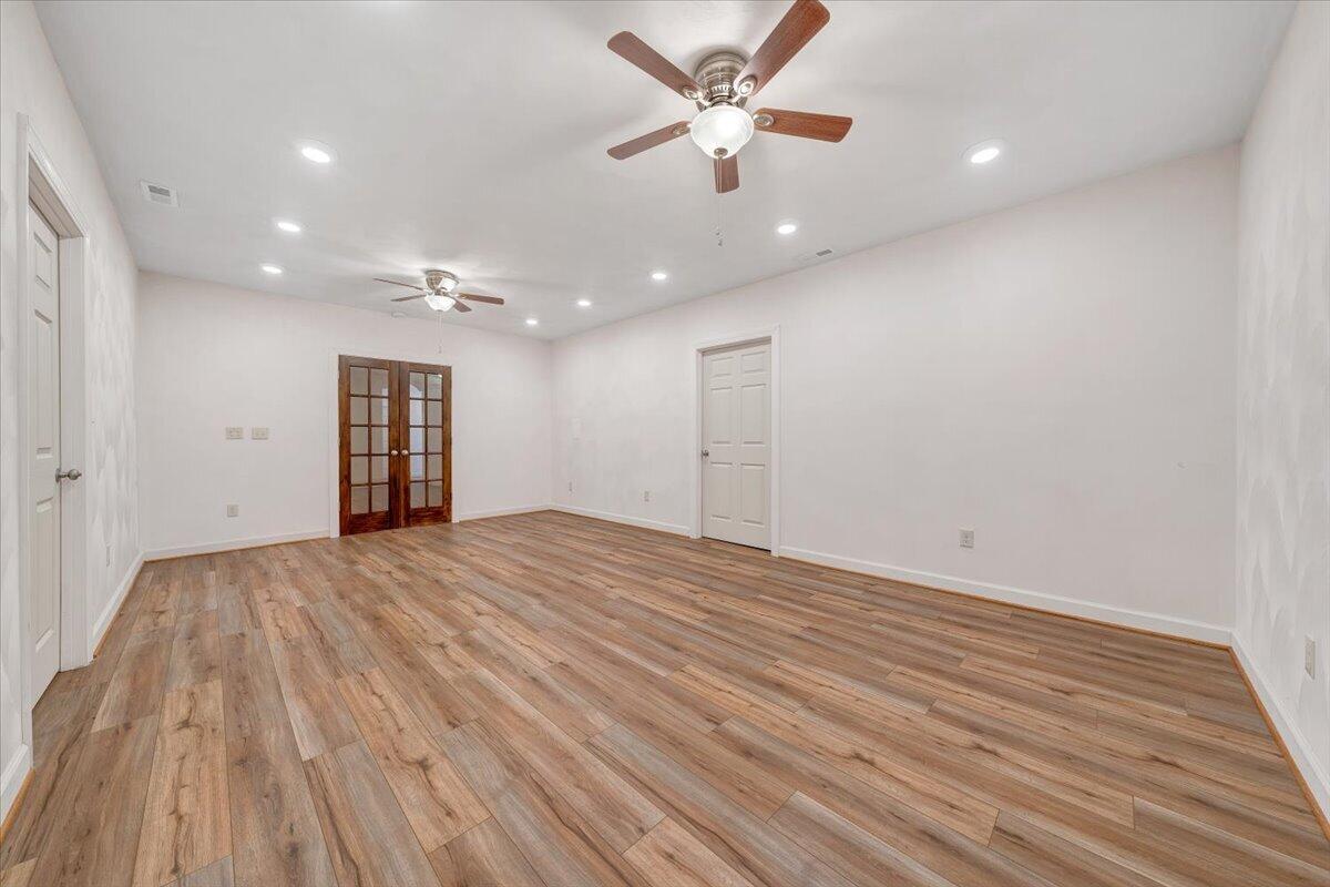 220 Settlers Road Fincastle, VA 24090 - Photo 71 of 106 an empty room with wooden floor and windows