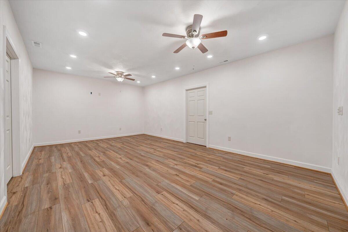 220 Settlers Road Fincastle, VA 24090 - Photo 72 of 106 an empty room with wooden floor and windows