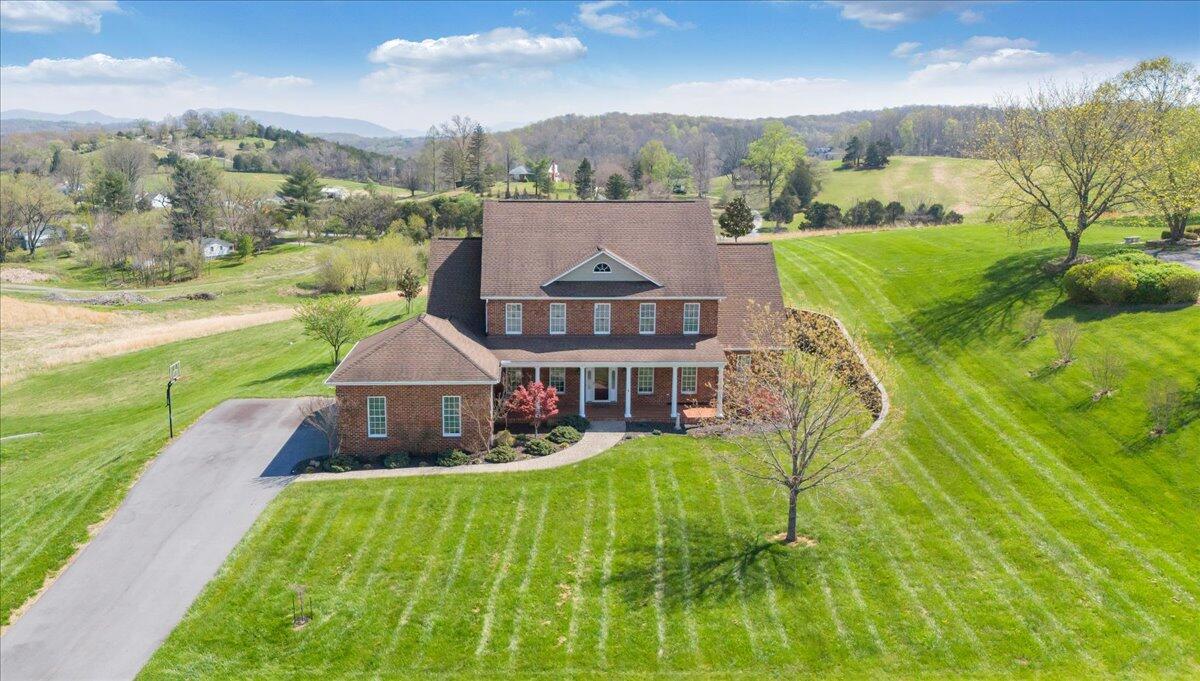 220 Settlers Road Fincastle, VA 24090 - Photo 10 of 106 a view of a big house with a big yard and large trees