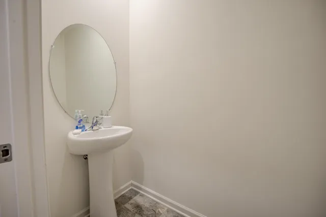 a bathroom with a sink and mirror