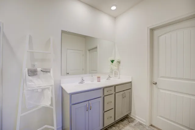a bathroom with a shower sink and mirror