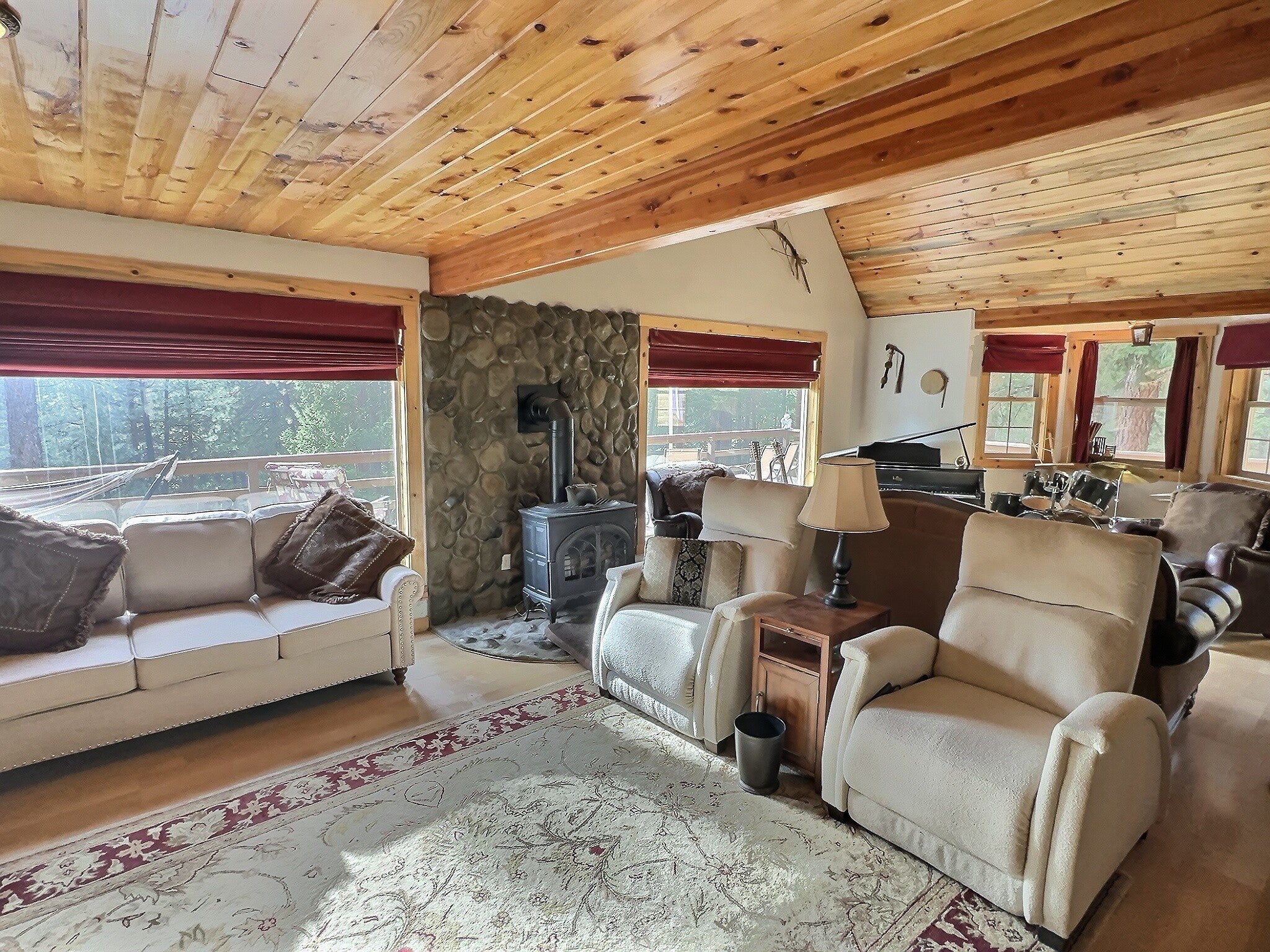 152 Buffalo Bill Road Plains, MT 59859 - Photo 8 of 71 Living room with a wood stove, wood ceiling, and vaulted ceiling