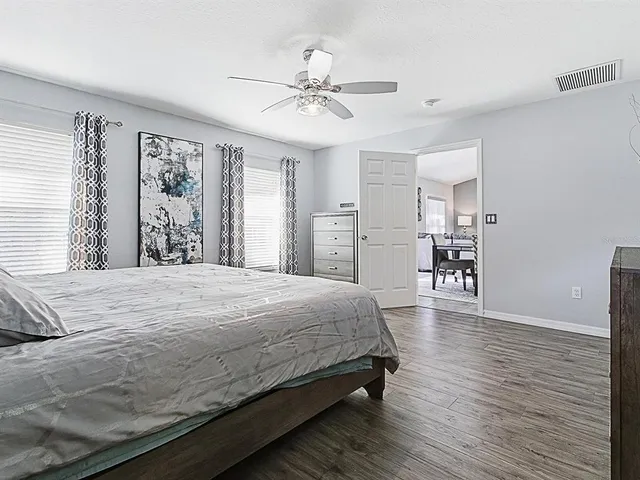 a bedroom with a large bed and a chandelier