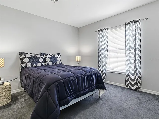 a bedroom with a bed and a chair