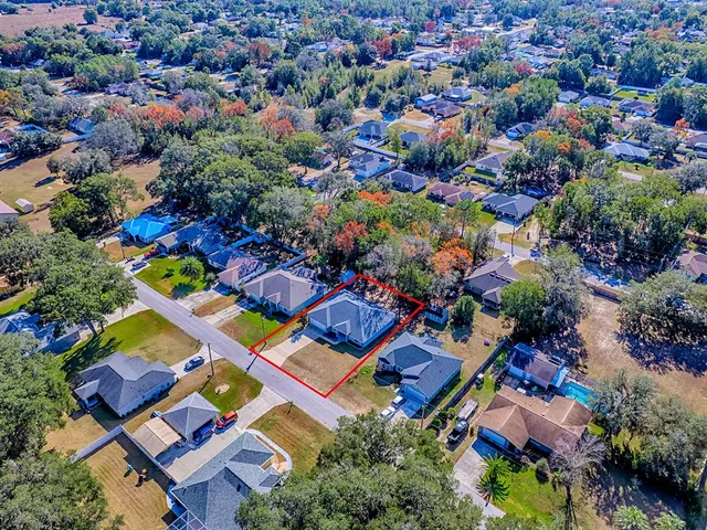 an aerial view of residential house with outdoor space and swimming pool