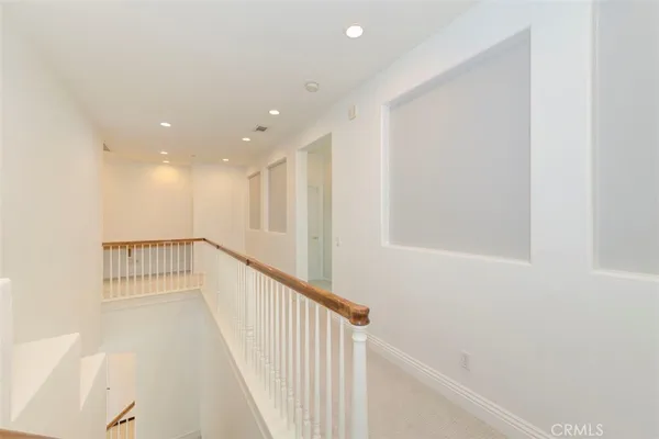 a view of a house with a yard and potted plants