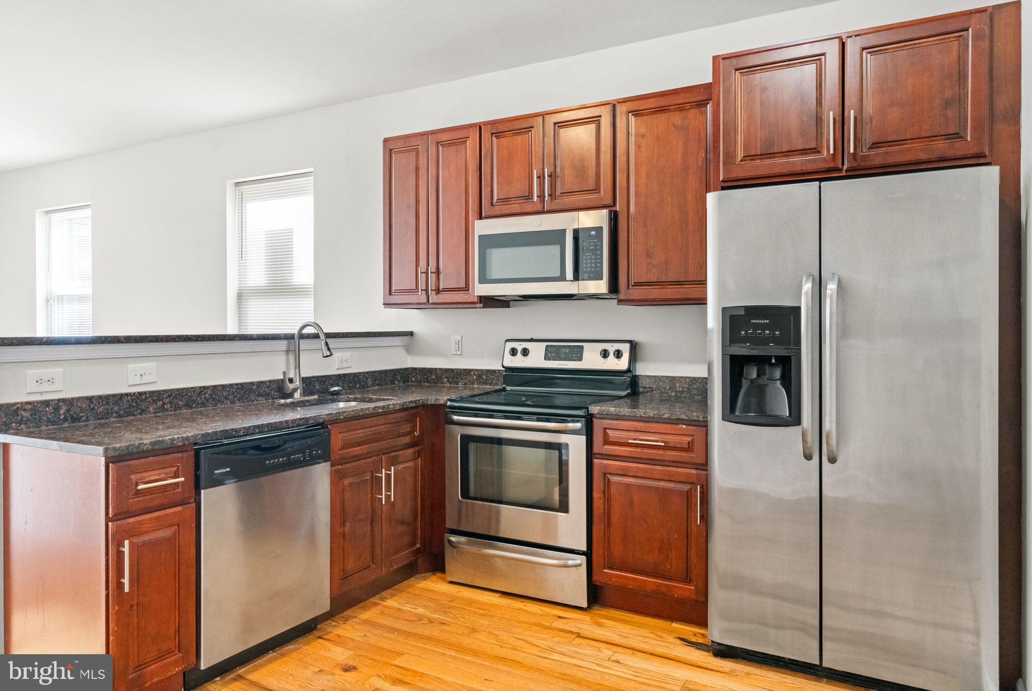 2106 North 17th Street Philadelphia, PA 19121 - Photo 12 of 84 a kitchen with stainless steel appliances granite countertop a stove a refrigerator and a sink
