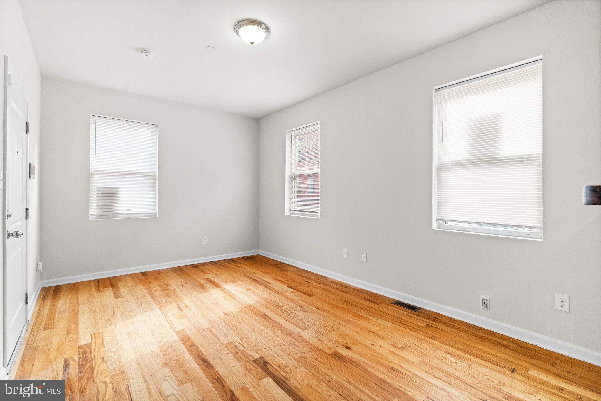 2106 North 17th Street Philadelphia, PA 19121 - Photo 19 of 84 a view of an empty room with wooden floor and a window