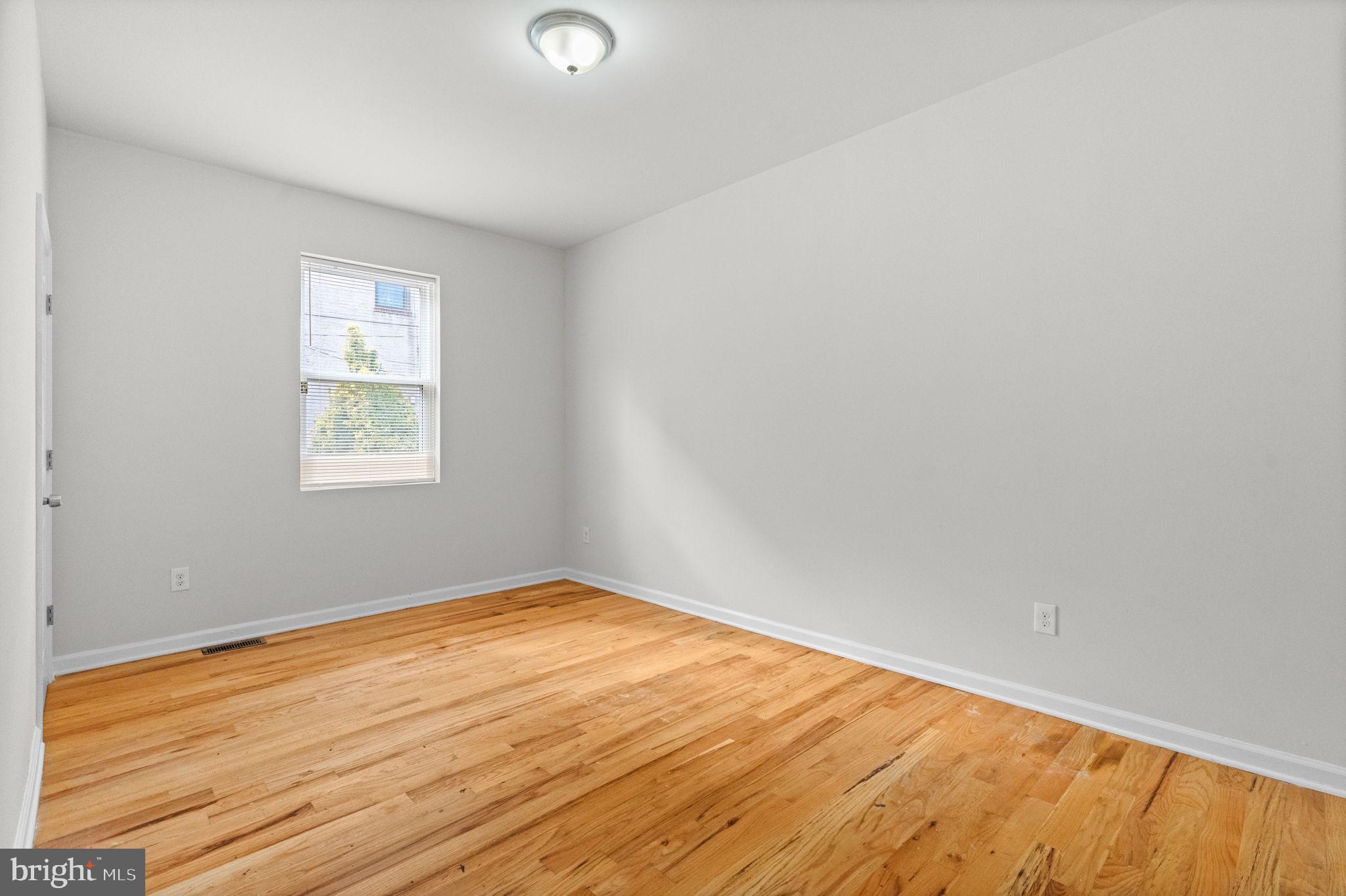 2106 North 17th Street Philadelphia, PA 19121 - Photo 2 of 84 an empty room with wooden floor and windows