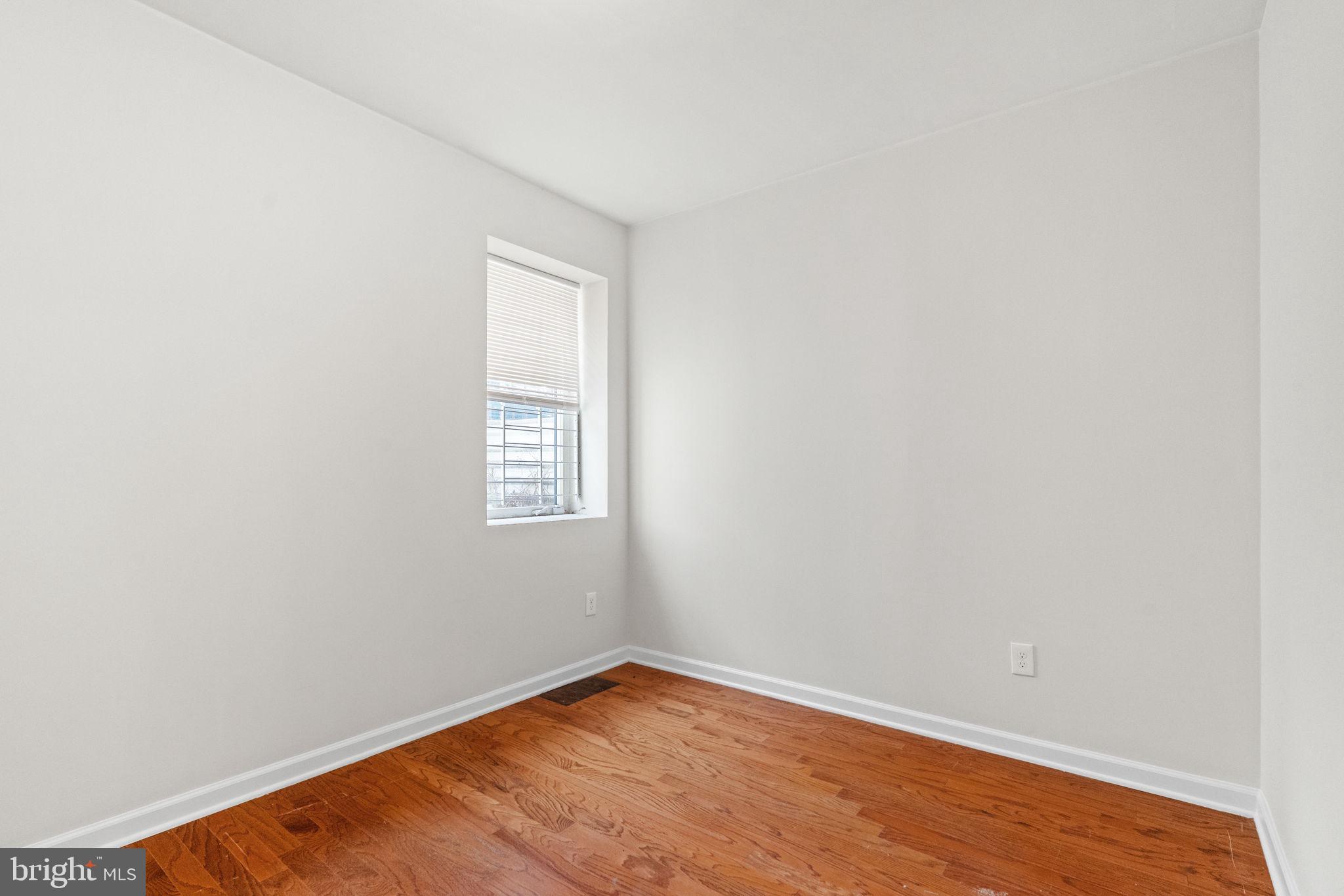 2106 North 17th Street Philadelphia, PA 19121 - Photo 23 of 84 a view of an empty room with wooden floor and a window