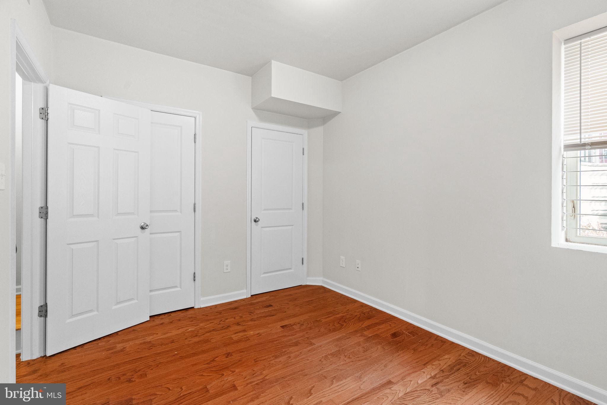2106 North 17th Street Philadelphia, PA 19121 - Photo 24 of 84 an empty room with wooden floor and windows