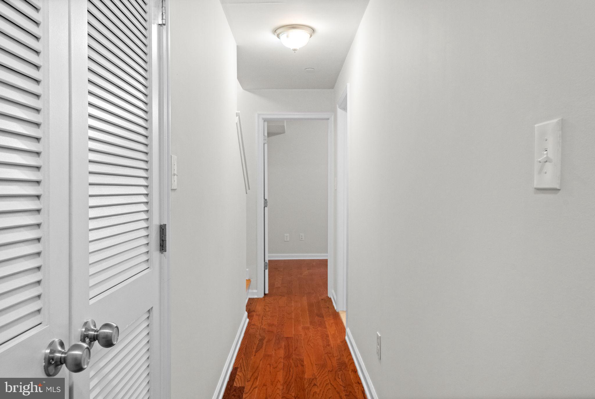 2106 North 17th Street Philadelphia, PA 19121 - Photo 28 of 84 a view of a hallway with wooden floor and a bathroom