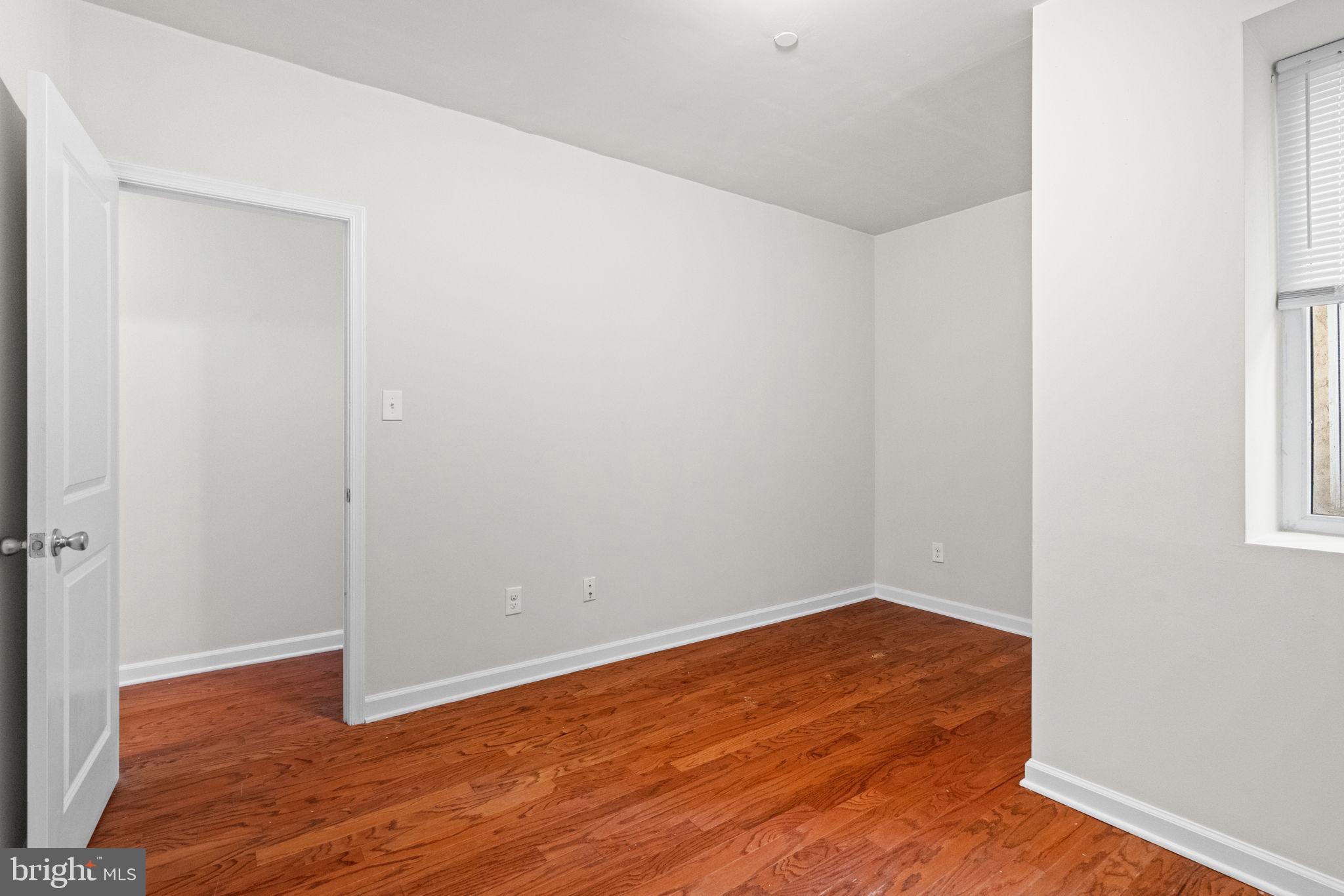 2106 North 17th Street Philadelphia, PA 19121 - Photo 40 of 84 a view of an empty room with wooden floor and a window